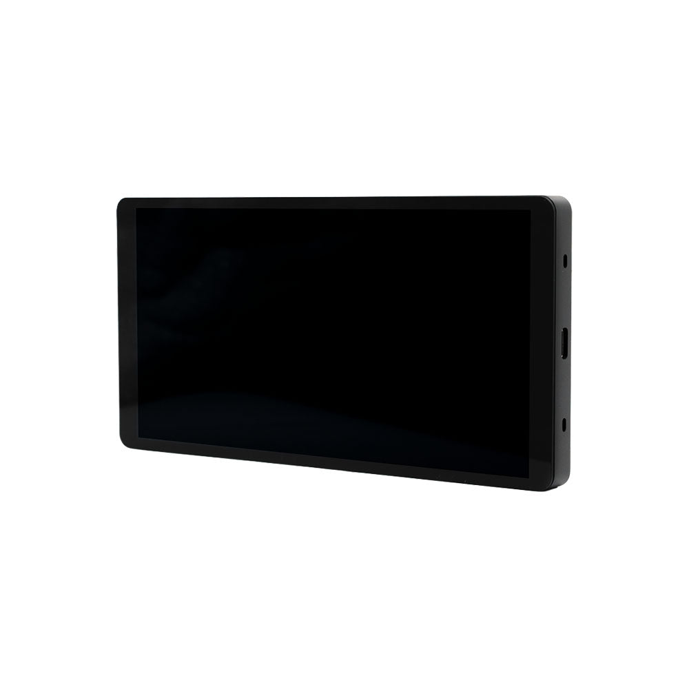 The Shelly Wall Display X2i Black, a rectangular tablet device with a large screen, is shown at a slight angle on a white background. Visible side ports provide connectivity.