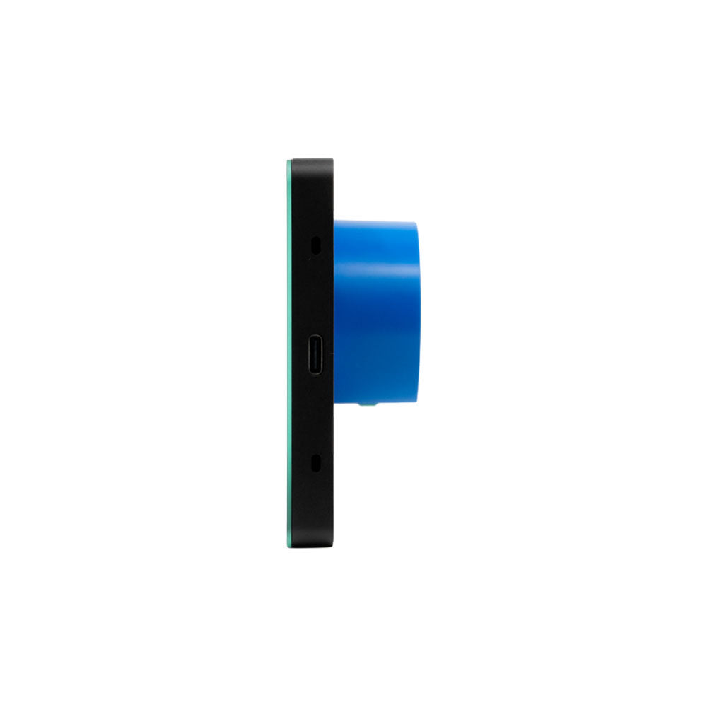 The Shelly Wall Display X2i Black is shown from the side, featuring a rectangular black body with a blue circular lens and a central USB-C port, all set against a plain white background.